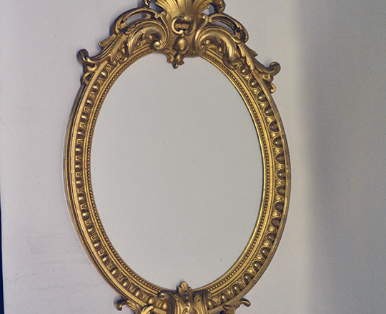 Lot 208: Turn cent Louis XVI gold leaf richly ornated oval mirror. H46cm.