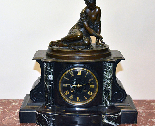 Lot 217: 19th c Nap.lll black marble mantle clock with bronze statue of kneeling girl with ball game. H39xW36cm.