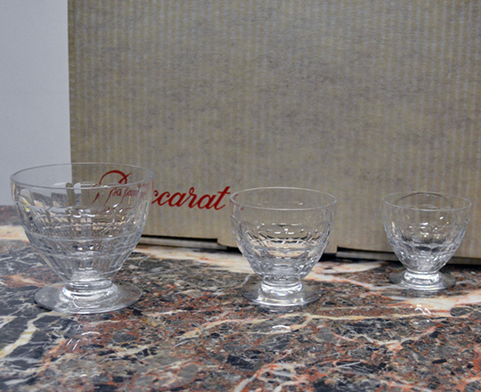 Lot 222: Three sets of various size Baccarat crystal glasses with original boxes.