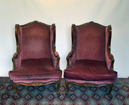 Lot 270: Large pair Louis XV style red velvet covered bergeres with 'ears' wing sides.