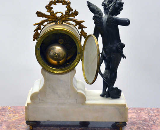 Lot 410_1: 19th c Louis XVI white marble mantle clock with bronze statue of Cupid beside mouvement by Butneau,Autun. H31cm.