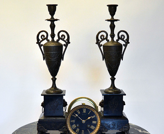 Lot 425: Pair Nap.lll candlesticks on a black marble base. H45cm.
