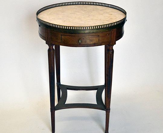Lot 540: 19th cent Louis XVI walnut? ''Bouillot'' round center table with marble top and brass gallery. H76 x dia 54cm.