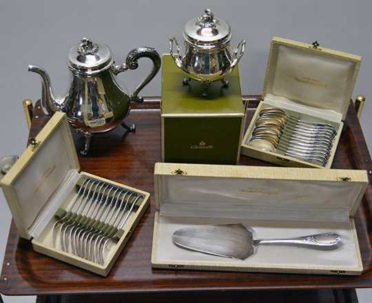 Lot 556: Christofle silver plated tea pot and sugar bowl plus two sets of (dessert) forks & spoons and cake knife.